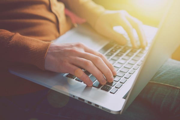 46573766 - hands with laptop typing in sunlight